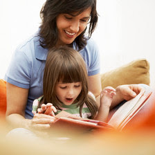 Mother and Daughter Reading Together --- Image by © Royalty-Free/Corbis